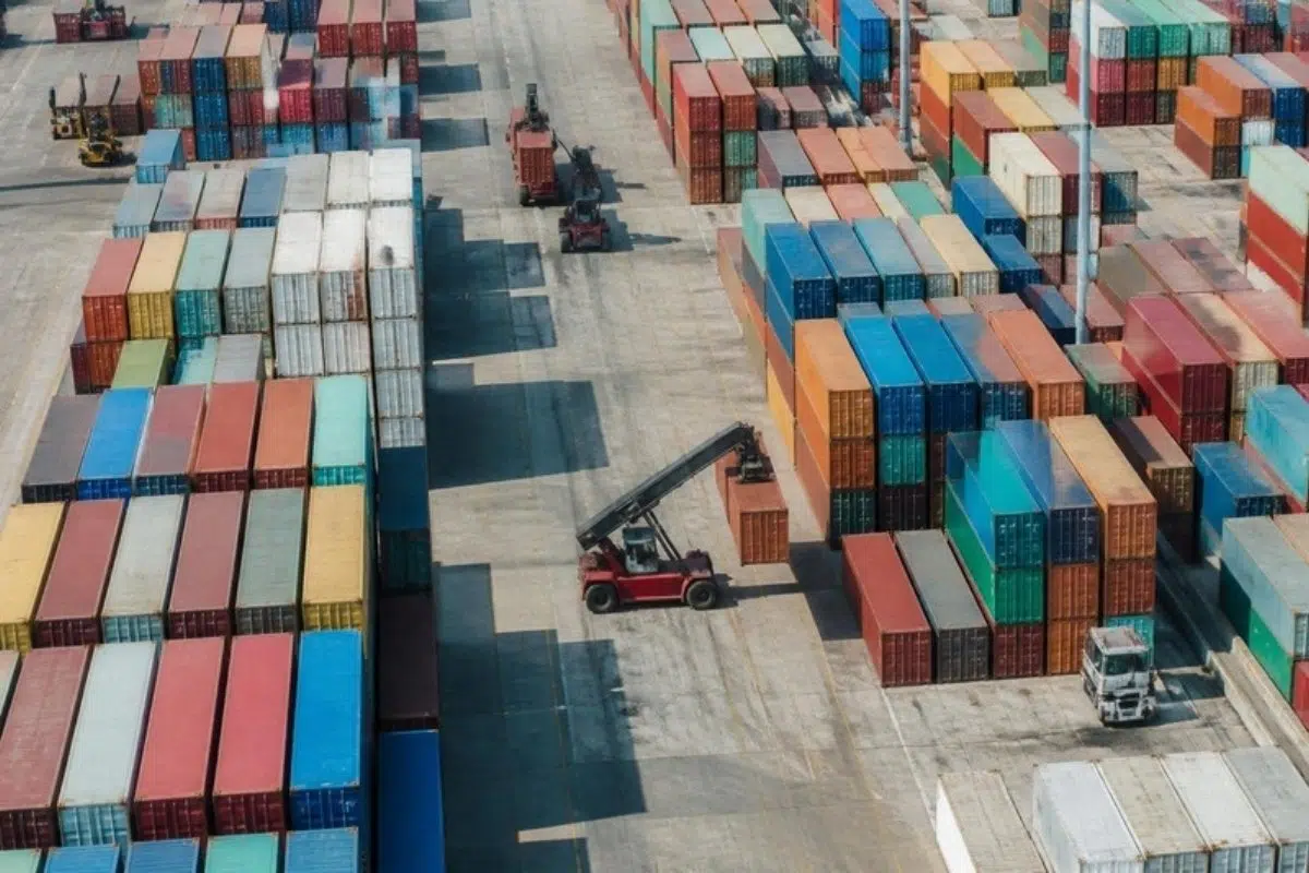 Aerial view of a busy container yard with stacked shipping containers