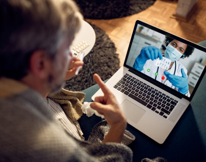 Close-up of man having video call with his doctor in the evening