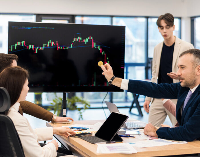 Young worker leading business meeting about cryptocurrencies in an office