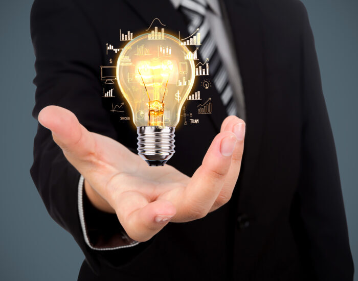 Business man holding light bulb