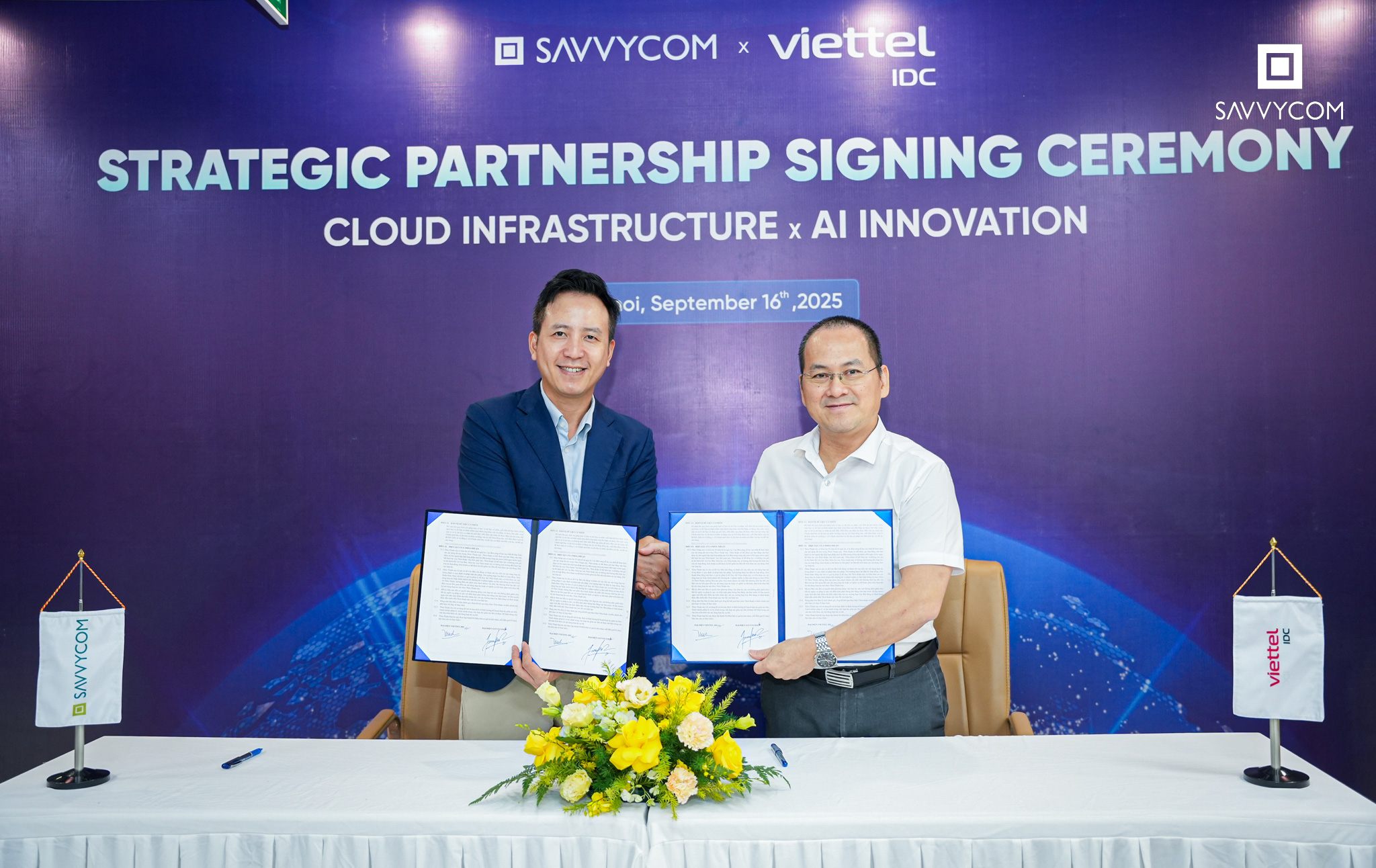 Mr. Nguyễn Quang Hưng of Savvycom and Mr. Lê Hoài Nam of Viettel IDC holding signed documents after the Strategic Partnership Signing Ceremony in Hanoi.